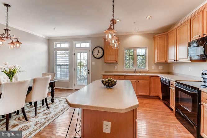 5136 Key View Way Perry Hall, MD 21128 - Photo 10 of 28 a kitchen with a table chairs a sink dishwasher window and cabinets