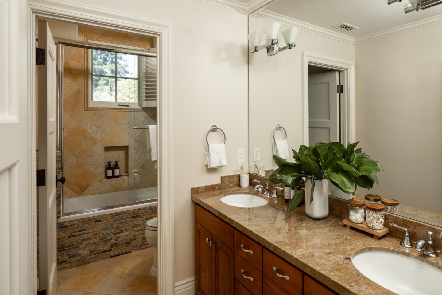 620 Windsor Drive Menlo Park, CA 94025 - Photo 11 of 18 a bathroom with a granite countertop sink a mirror and shower