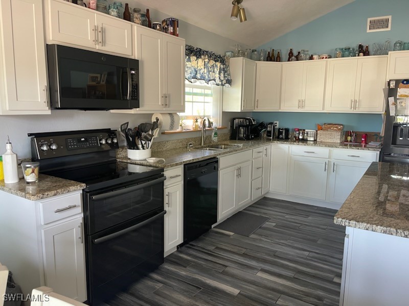 10796 Russell Road Bokeelia, FL 33922 - Photo 20 of 47 a kitchen with a sink stove and microwave