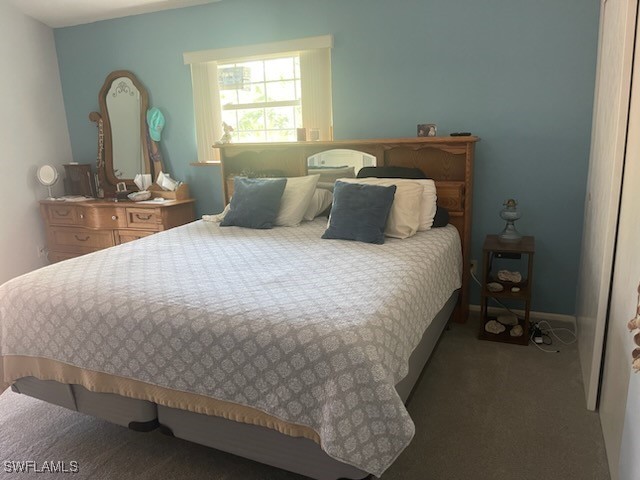 10796 Russell Road Bokeelia, FL 33922 - Photo 27 of 47 a bed sitting in a bedroom next to a window