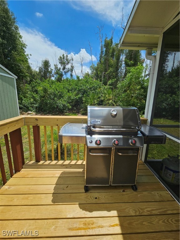 10796 Russell Road Bokeelia, FL 33922 - Photo 32 of 47 a view of balcony with wooden floor and outdoor seating
