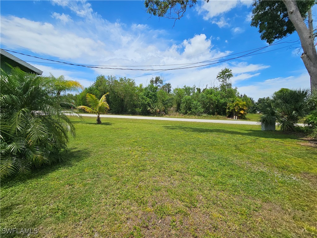 10796 Russell Road Bokeelia, FL 33922 - Photo 40 of 47 a view of outdoor space with deck and yard