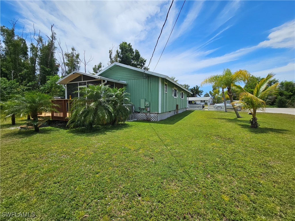 10796 Russell Road Bokeelia, FL 33922 - Photo 41 of 47 a view of a house with a yard