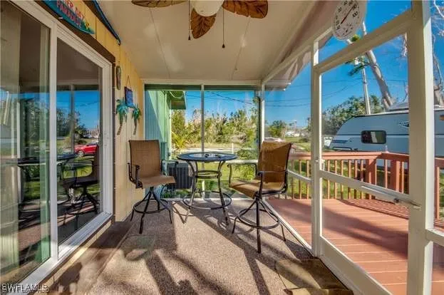 a view of a chairs and table in a balcony