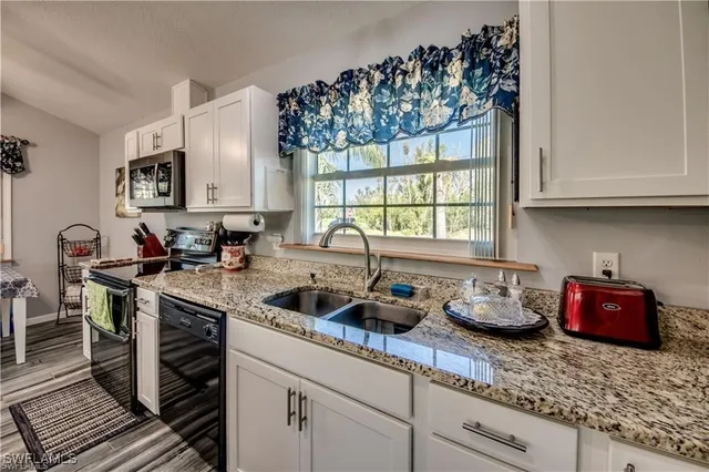 a kitchen with sink cabinets and a window