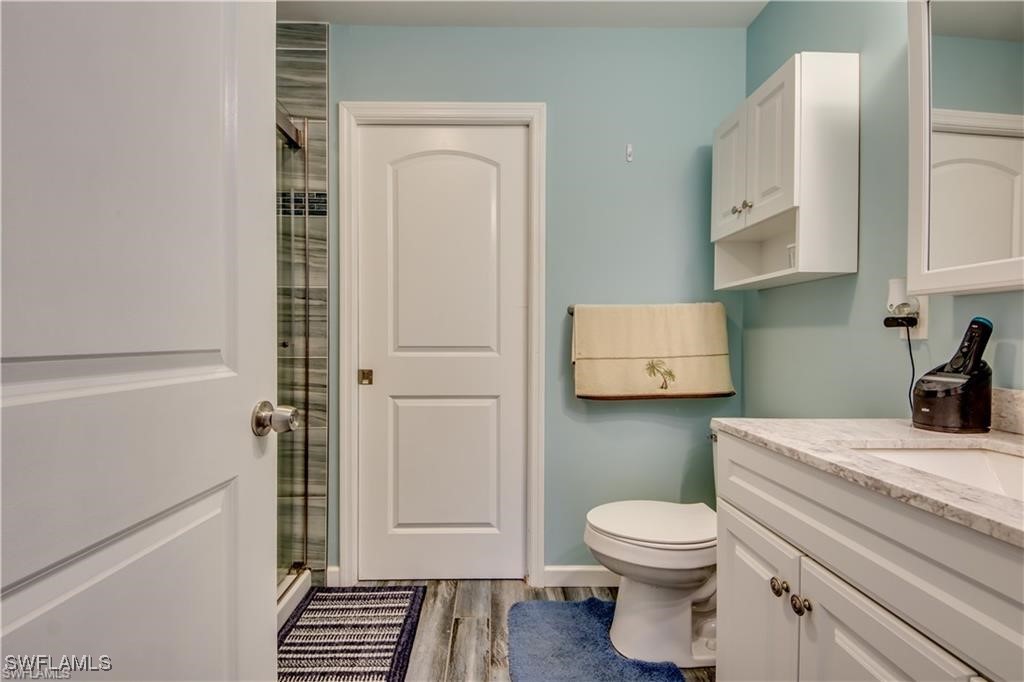 10796 Russell Road Bokeelia, FL 33922 - Photo 9 of 47 a bathroom with a toilet and a sink