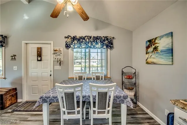 a view of a dining room with furniture wooden floor and chandelier