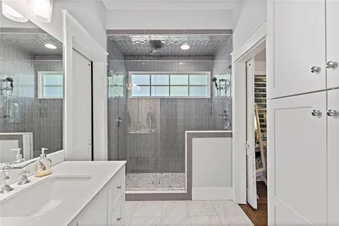 a bathroom with a sink a shower and a mirror