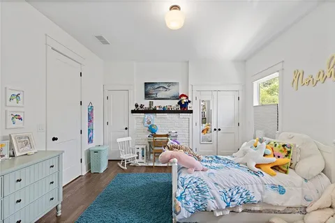 a bedroom with furniture and a wooden floor