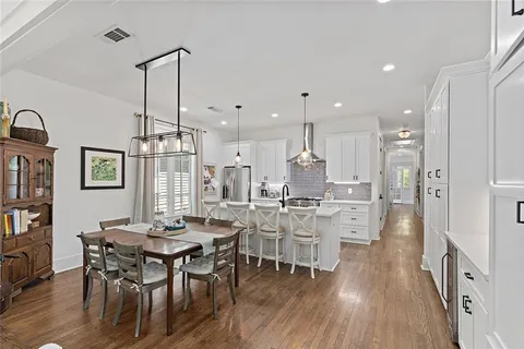 a view of a dining room with furniture and wooden floor