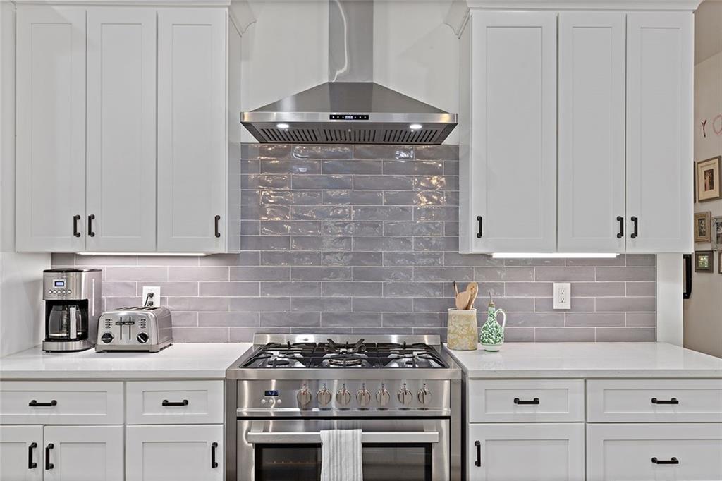 221 3rd Avenue Decatur, GA 30030 - Photo 23 of 37 a kitchen with granite countertop a stove top oven a sink and cabinets