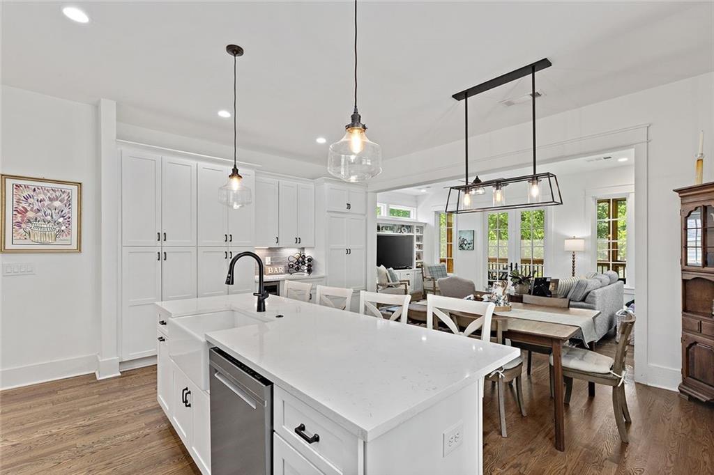 221 3rd Avenue Decatur, GA 30030 - Photo 24 of 37 a kitchen with sink stove and white cabinets with wooden floor