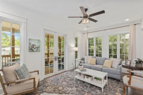 a living room with furniture and a large window with wooden floor