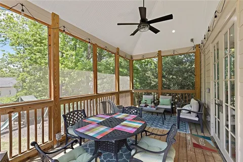 a living room with furniture a table and a large window