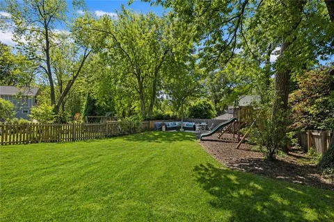 a view of a house with a backyard