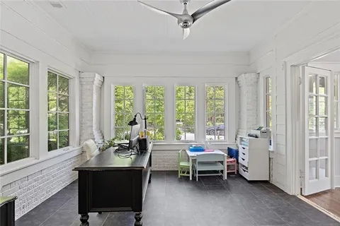 a living room with furniture and a floor to ceiling window