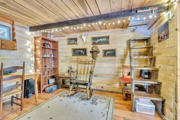a view of a walk in closet with wooden floor and door
