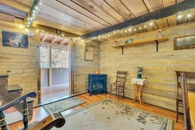 a backyard of a house with wooden fence and a large tree