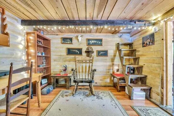 a view of a small house with a tree in the background