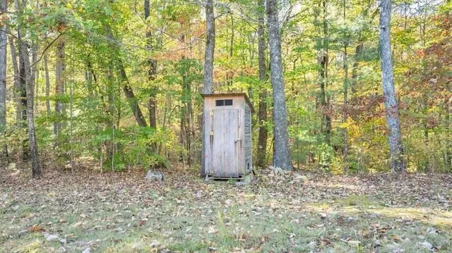a view of a field with trees in the background