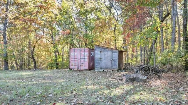 a backyard of a house with table and chairs