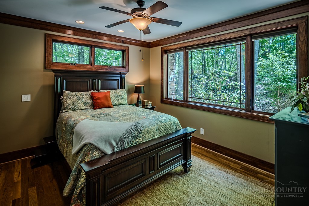 485 Woodlake Loop Road Elk Park, NC 28622 - Photo 15 of 44 a bed sitting in a spacious bedroom next to a window