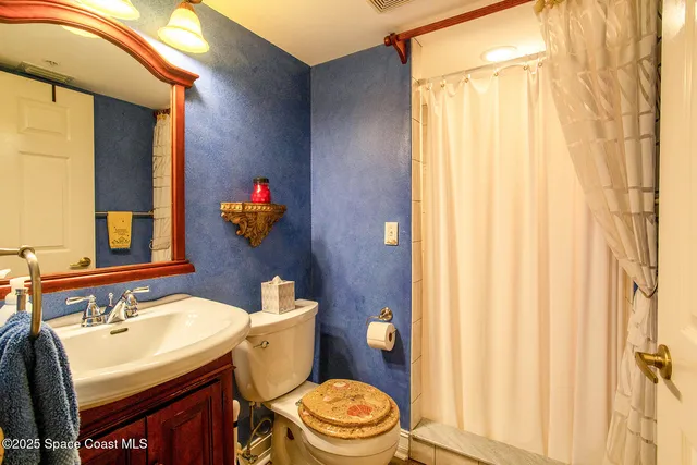 a view of a livingroom with a floor to ceiling window and a flat screen tv