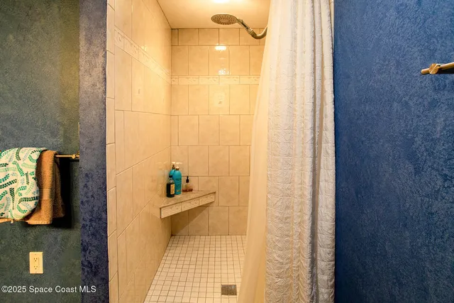 a front view of a building with a garden and plants