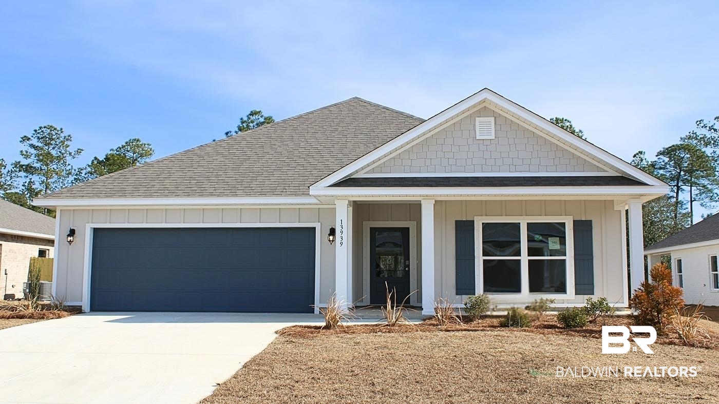 View of front of house with a lawn and a garage
