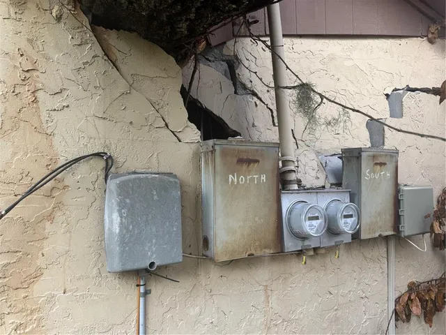 a view of a house with a backyard and trees