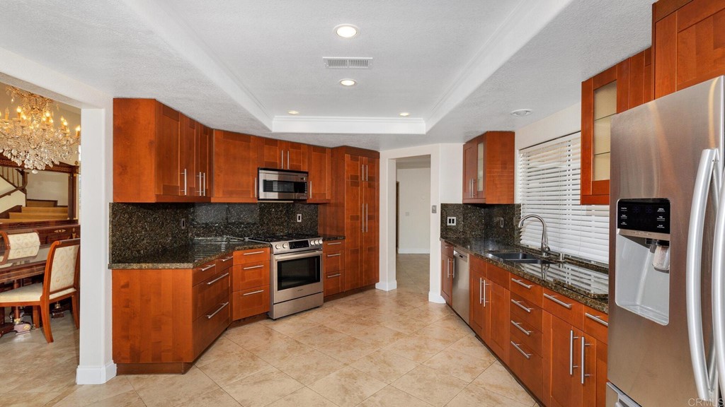 5979 Corte Playa Pacifica San Diego, CA 92124 - Photo 11 of 38 a kitchen with stainless steel appliances granite countertop a stove top oven a sink and dishwasher