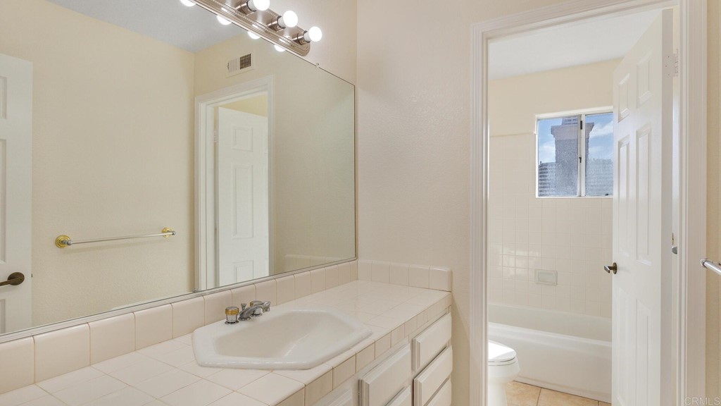 5979 Corte Playa Pacifica San Diego, CA 92124 - Photo 29 of 38 a bathroom with a sink and a mirror