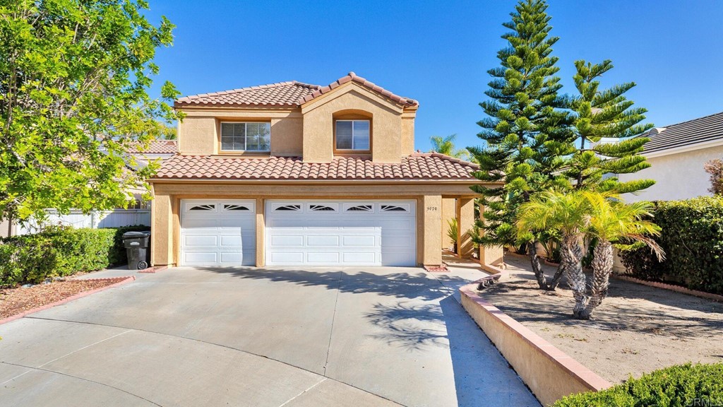 5979 Corte Playa Pacifica San Diego, CA 92124 - Photo 4 of 38 a front view of a house with garden
