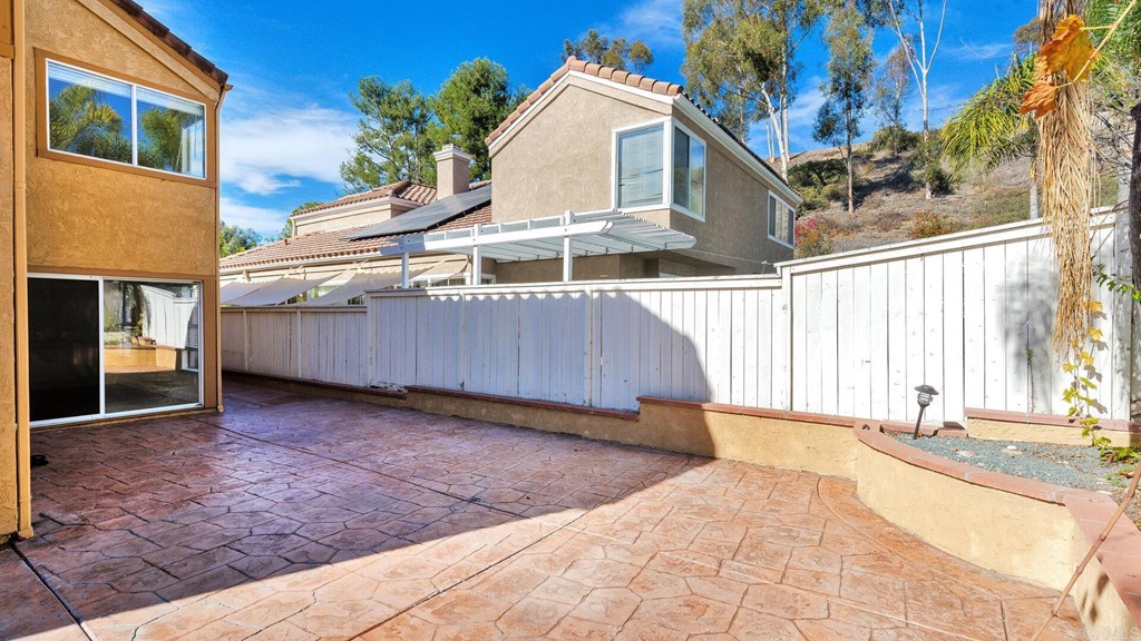 5979 Corte Playa Pacifica San Diego, CA 92124 - Photo 34 of 38 a view of a house with a backyard and balcony
