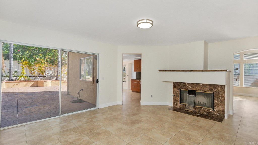 5979 Corte Playa Pacifica San Diego, CA 92124 - Photo 5 of 38 an empty room with furniture and a fireplace