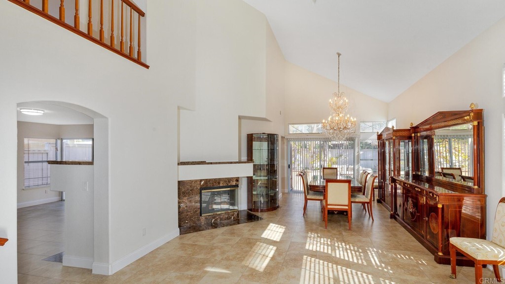 5979 Corte Playa Pacifica San Diego, CA 92124 - Photo 8 of 38 a living room with furniture a fireplace and a chandelier