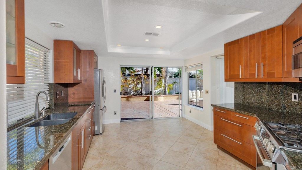 5979 Corte Playa Pacifica San Diego, CA 92124 - Photo 10 of 38 a large kitchen with stainless steel appliances granite countertop a sink and cabinets