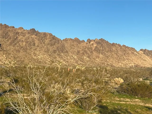 a view of a large mountain with mountains in the background
