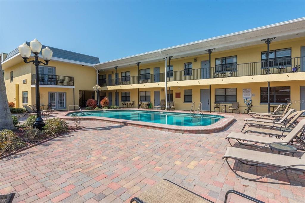 16333 Gulf Boulevard, Unit 204 Redington Beach, FL 33708 - Photo 14 of 43 front view of a building with a yard