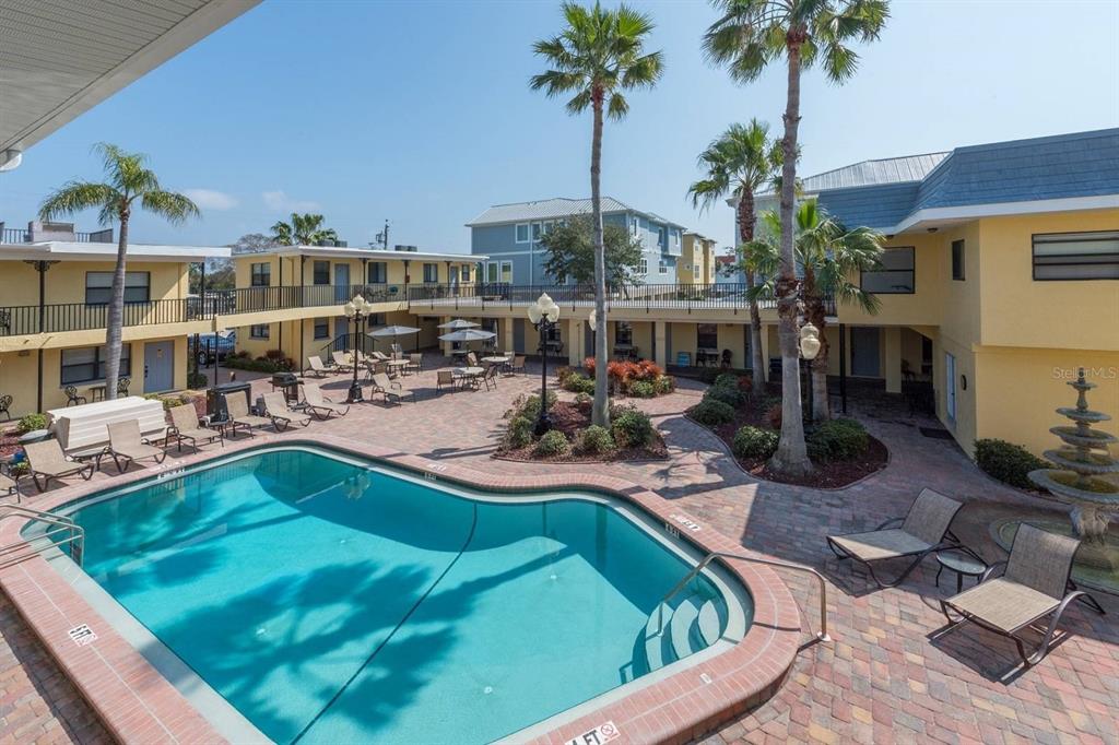 16333 Gulf Boulevard, Unit 204 Redington Beach, FL 33708 - Photo 3 of 43 a view of a swimming pool with chairs