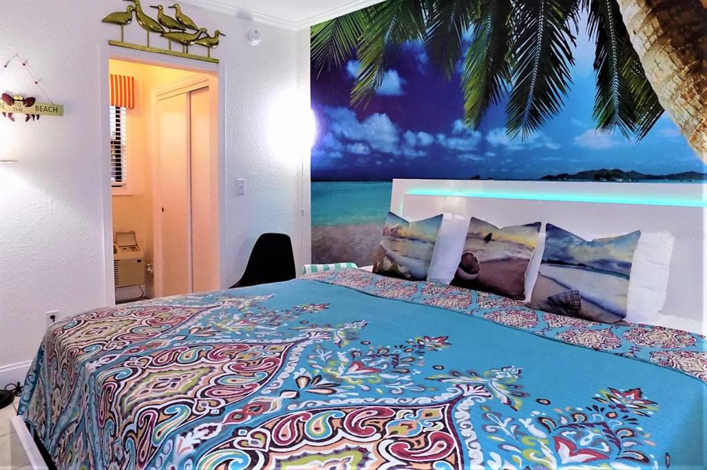 16333 Gulf Boulevard, Unit 204 Redington Beach, FL 33708 - Photo 9 of 43 a bed room with a bed and a painting on the wall