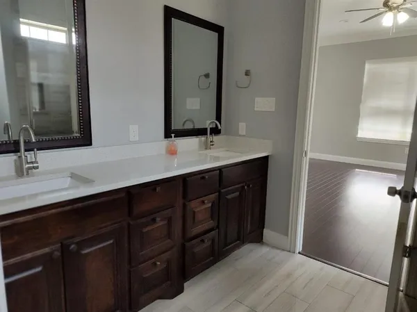 a bathroom with a double vanity sink and a mirror