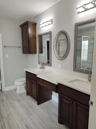 a bathroom with a double vanity sink and a mirror