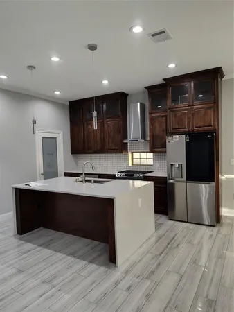 a kitchen with stainless steel appliances granite countertop a stove and a sink