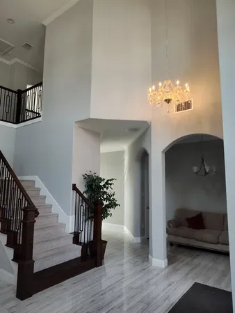 a view of entryway and hall with wooden floor