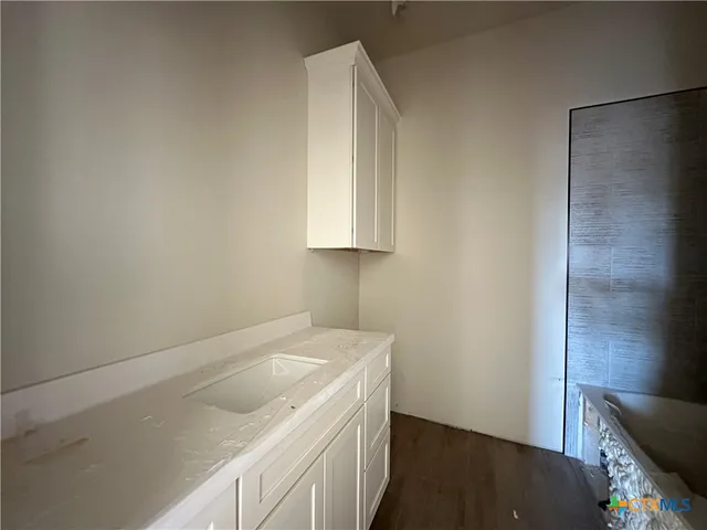 a utility room with a sink dryer and washer