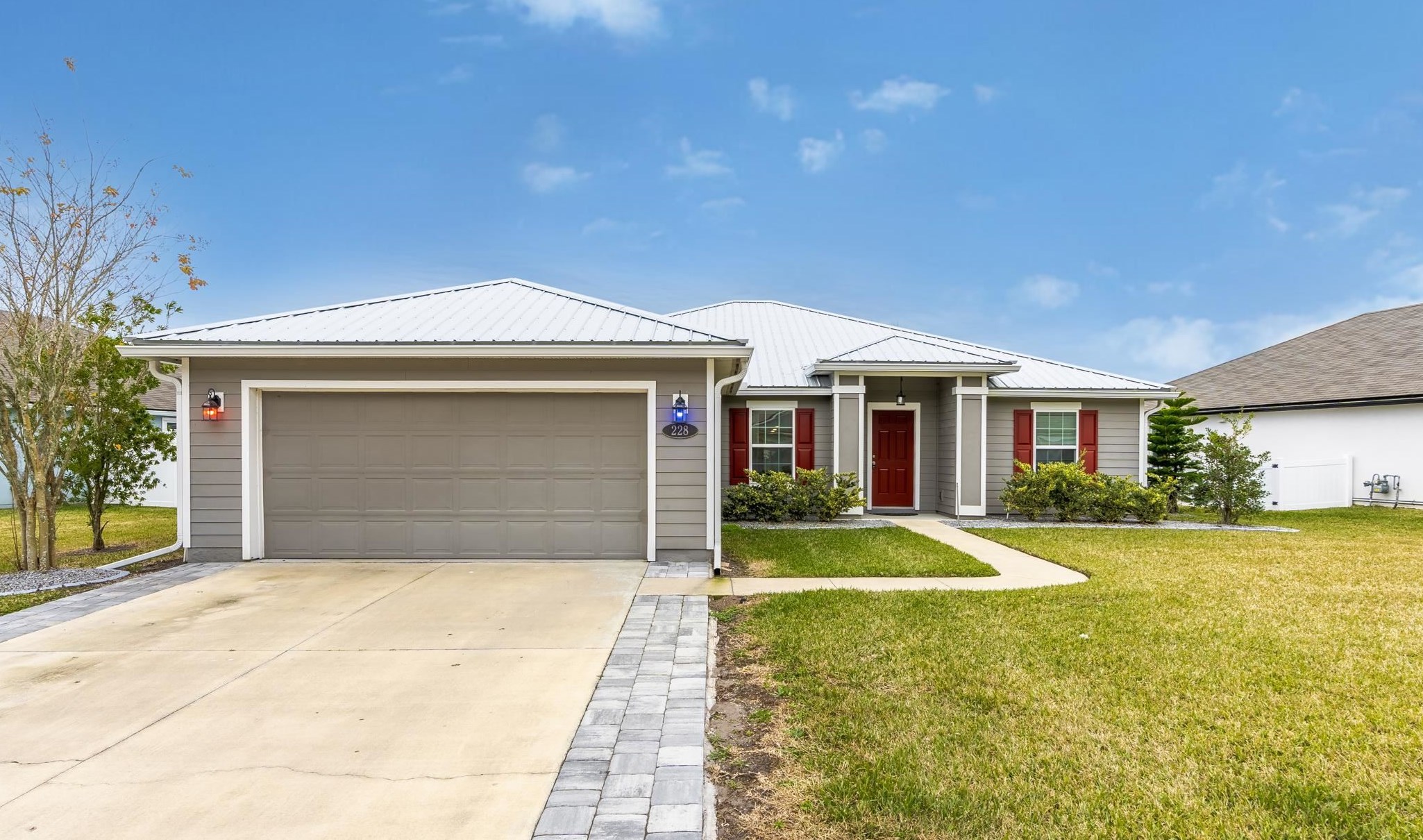 228 Fox Water Trail St. Augustine, FL 32086 - Photo 1 of 50 a front view of a house with a yard and garage