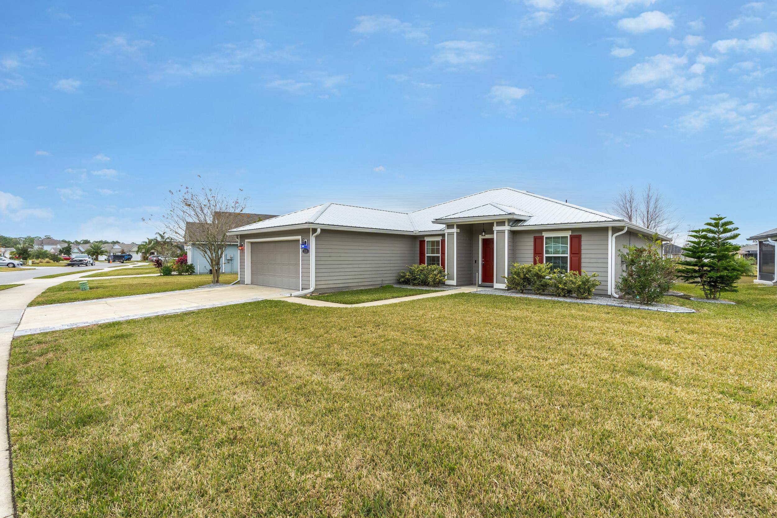 228 Fox Water Trail St. Augustine, FL 32086 - Photo 2 of 50 a front view of a house with garden