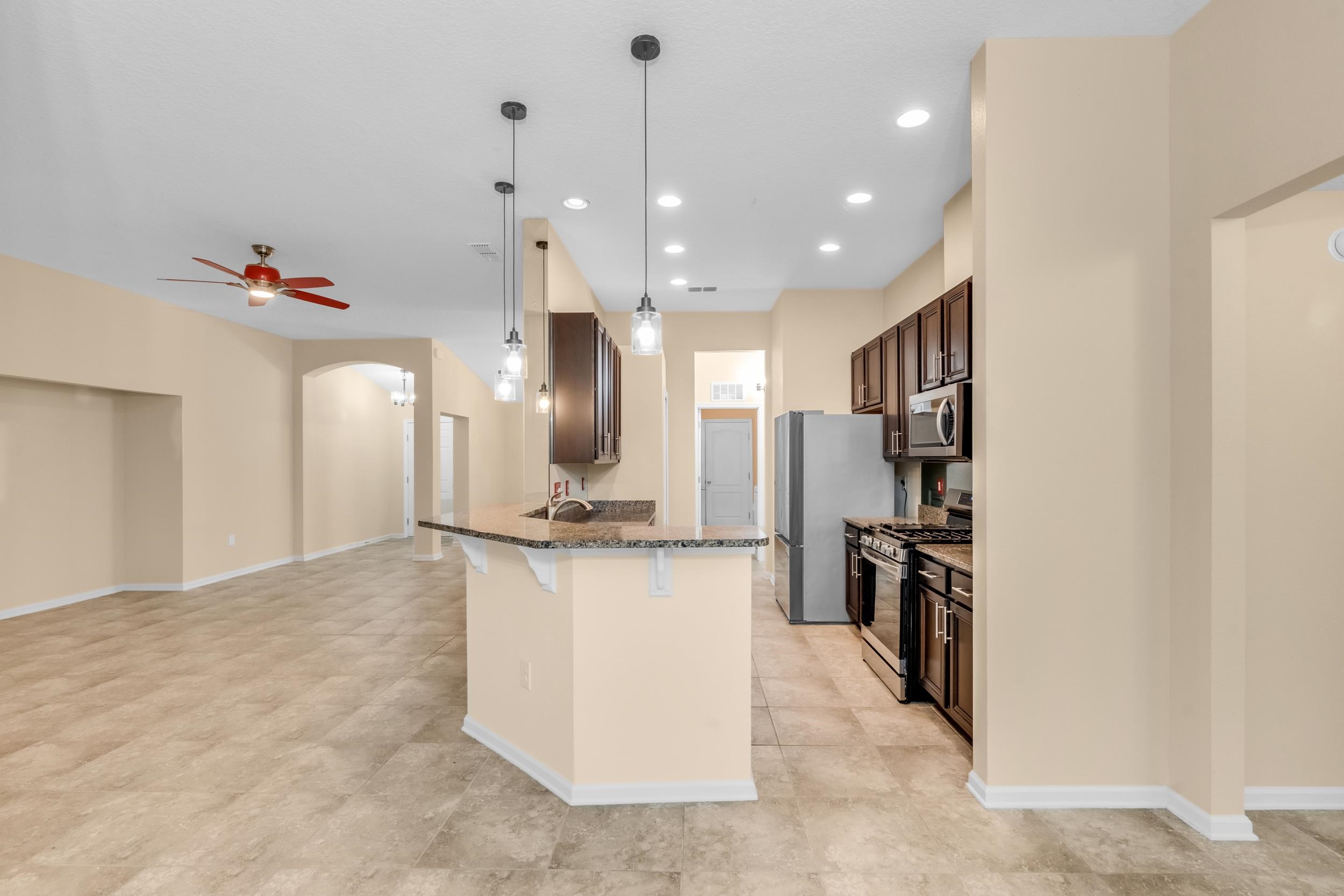 228 Fox Water Trail St. Augustine, FL 32086 - Photo 21 of 50 a view of a kitchen with refrigerator and wooden floor