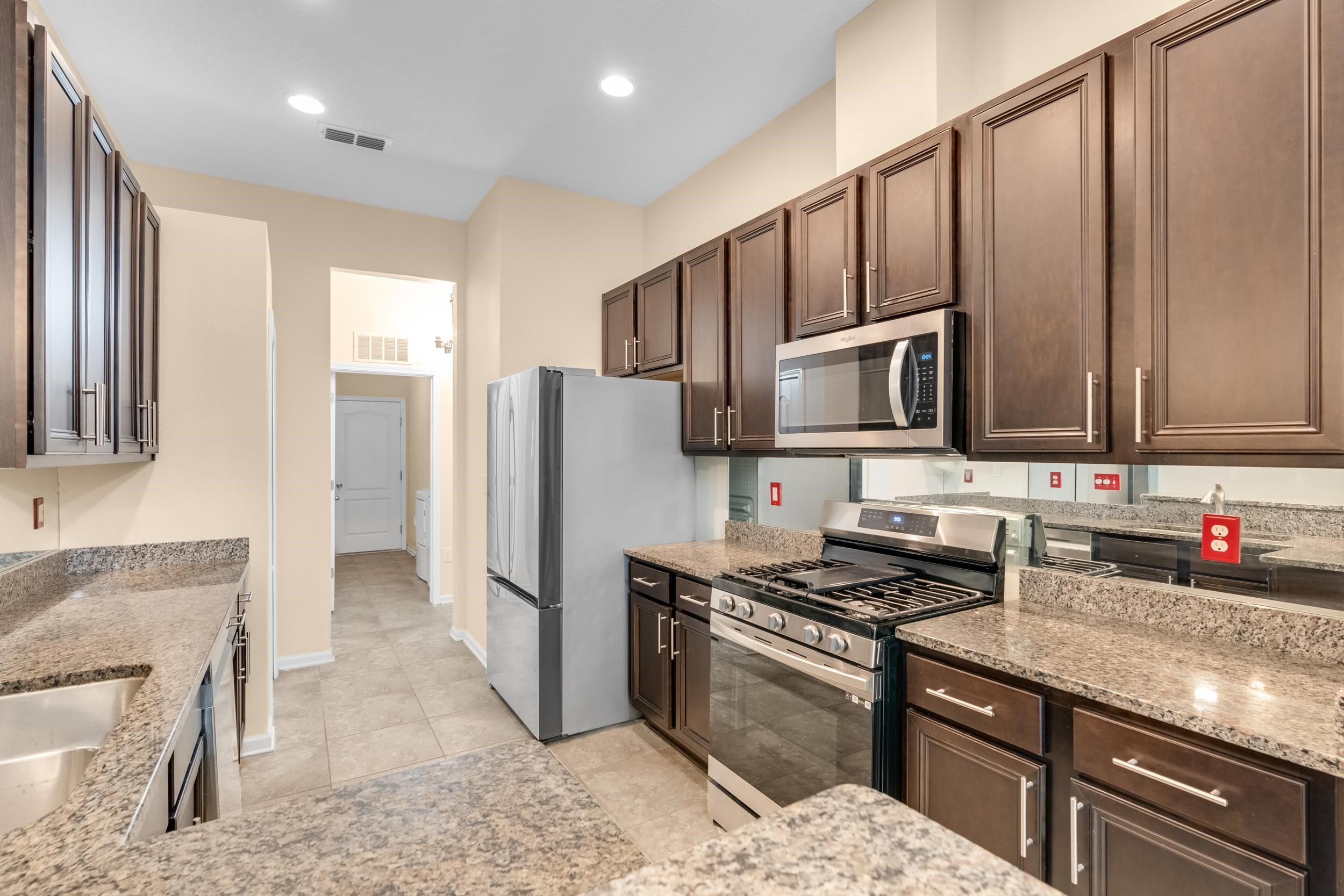 228 Fox Water Trail St. Augustine, FL 32086 - Photo 25 of 50 a kitchen with stainless steel appliances granite countertop a refrigerator stove and sink